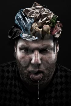 Ignorance concept. Heap of garbage inside silly man head