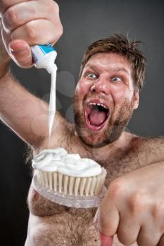 Ugly man preparing to brushing teeth