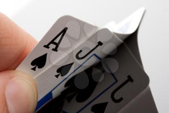 Close-up of blackjack cards in palm of hand