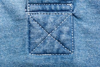 A closeup of seams on jeans fabric