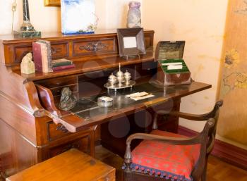 Retro writing table with books, statues and other equipment