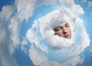 Adult man's face in the sky in clouds