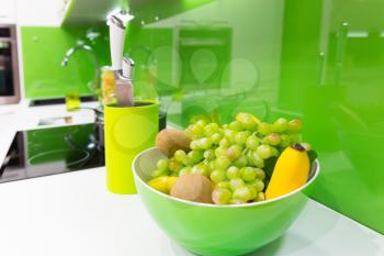 Modern green kitchen interior shot with grapes