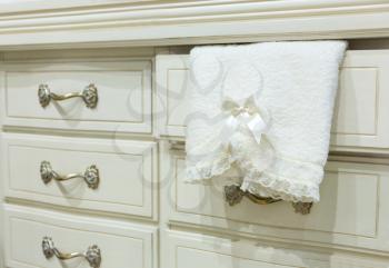 Vintage mansion white chest of drawers with a towel