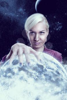 Mystic fortune teller woman holding a planet ball in the night