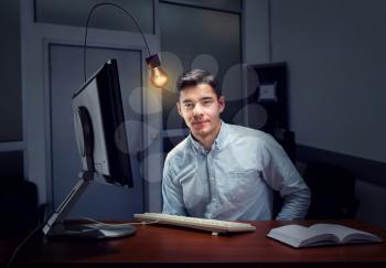 Young businessman working in the office in the evening