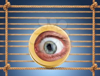 Human eye in the coin over rope net background