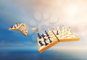 Chess boards with chessmen flying in the air