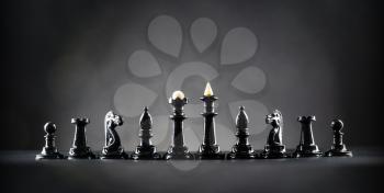 Black chess figures on the table over black