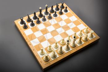 Chess figures on the board ready to fight