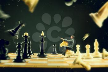 Businessman sitting on the knight fighting on the chess board