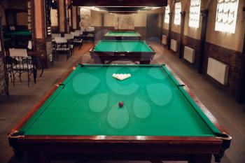 Modern billiard saloon with table prepared for play