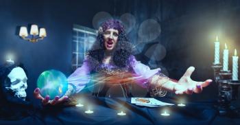 Angry sorceress working with crystal ball