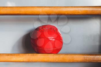 Red med ball on the shelf in the gym