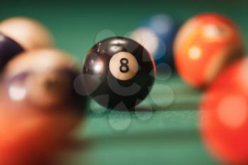 Pool ball with number 8 over green background. Pool theme.