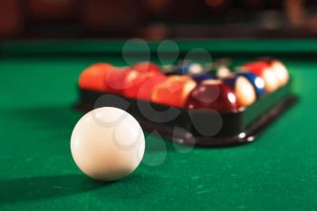 White ball on the green cloth of the billiard table.