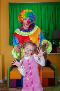 Surprise on birthday party, parents have invited the clown. Baby birthday celebration concept. 