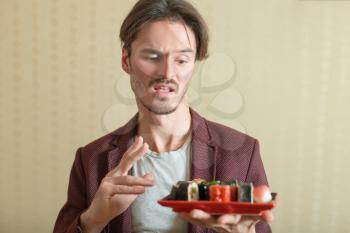 Man holds not fresh sushi set