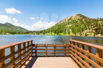 Wooden berth on lake against Rocky Mountain National Park USA