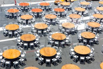Top view of wooden street cafe tables and chairs.