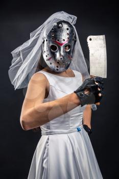 Bride in hockey mask with meat cleaver. Serial murederer in wedding dress