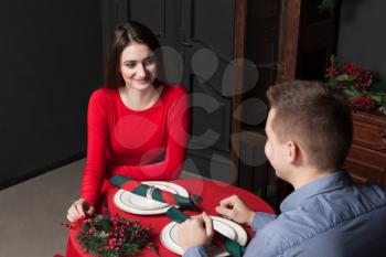 Young smiling couple at luxury restaurant. Romantic date, man and woman in love