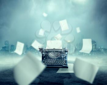 Vintage typewriter with the inserted sheet of paper, foggy urban landscape and dark river on background, documents flying all around. Hot business news creative concept