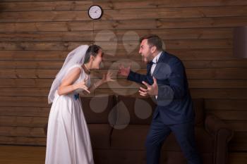 Bride and groom shouting at each other. Newlyweds complex relationship