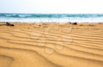 Sandy waves on Sri Lanka coast, selective focus view. Ceylon beach, indian ocean