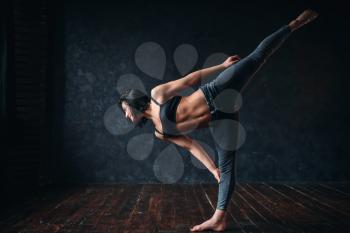 Body flexibility, contemp style dancing in dance class. Female dancer poses in studio