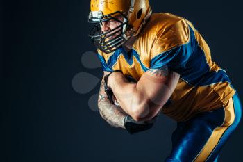 American football offensive player, national league, black background. Contact sport