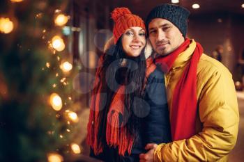 Winter evening, city walking of smiling love couple. Man and woman having romantic meeting, happy couple