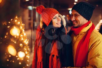 Winter evening, city walking of smiling love couple. Man and woman having romantic meeting, happy relationship