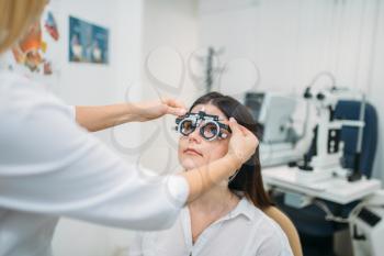Diopter selection, diagnostics of vision, professional choice of glasses. Eyesight test in optician cabinet. Patient and ophthalmologist, eye care consultation