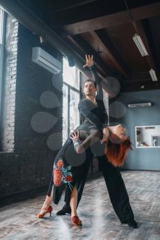 Man and woman on ballrom dance training in class. Female and male partners on professional pair dancing in studio