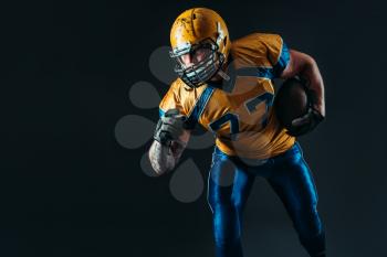 American football offensive player, national league, black background. Contact sport