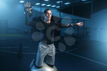 Athletic man on training, workout on press in gym. Active exercises in sport club