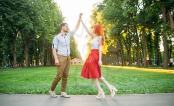 Romantic date, love couple happiness together, meeting in summer park. Attractive woman and young man leisure outdoors