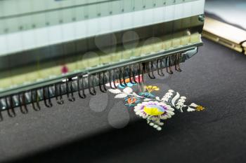 Sewing machine in work, color textile fabric, nobody. Factory production, sew manufacturing, needlework technology