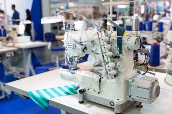 Overlock machine, nobody, clothing sew on fabric. Factory production, cloth manufacturing, needlework technology