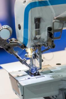 Sewing machine closeup, nobody, dressmaker equipment, cloth industry. Factory production, sew manufacturing Clothing fabric
