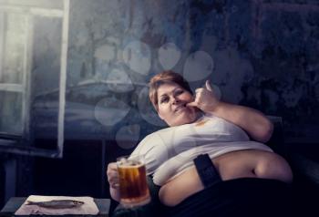Overweight woman with glass of beer in hand, obesity. Unhealthy lifestyle, fatty female