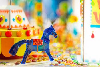 Handmade sugar caramel horse in showcase of candy store closeup, nobody. Treats for children