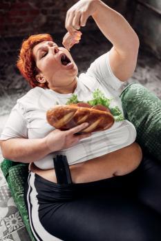 Overweight woman eats sandwich, bulimic, obesity problem. Unhealthy lifestyle, fat female
