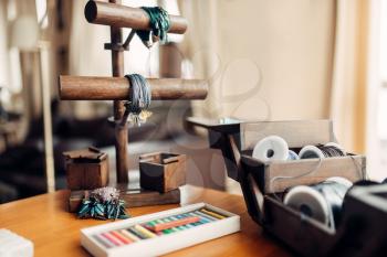 Needlework hobby, handicraft tools, closeup. Equipment of a craftsman, handmade bracelets and bijouterie