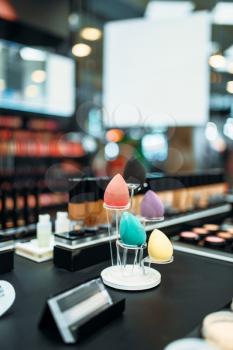 Make-up cosmetic collection in beauty shop closeup, nobody. Makeup products on showcase in store