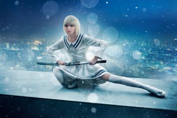 Anime style blonde girl with sword on the edge of the skyscraper roof. Cosplay woman, japanese culture, doll with blade in cold tones, cityscape on background