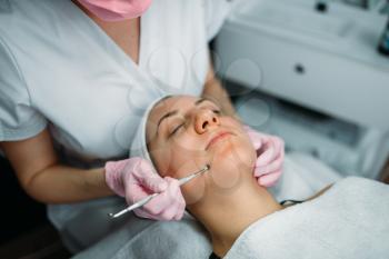 Professional facial skincare in spa salon, rejuvenation procedure, health care. Beauty medicine in cosmetology cabinet