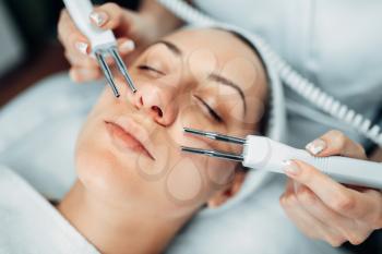 Face rejuvenation procedure to woman, beauty medicine, cosmetology clinic. Facial skincare in spa salon