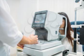 Computer diagnostics of vision, professional choice of eyeglasses. Eyesight test in optician cabinet. Patient and doctor, eye care consultation, glasses diopter selection